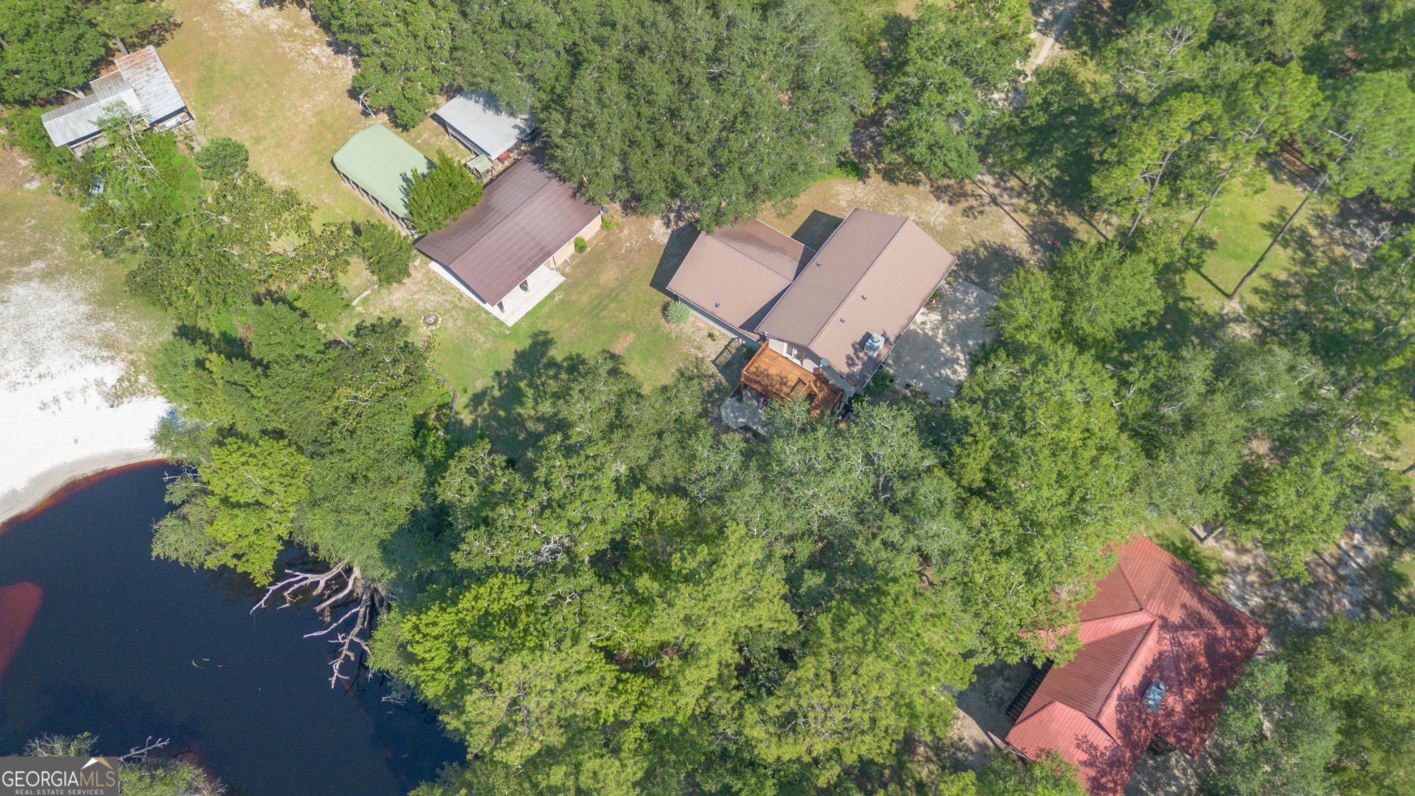 323 St Marys River Bluff Road St. George, GA 31562 - Photo 43 of 43 an aerial view of a house with a yard and outdoor seating