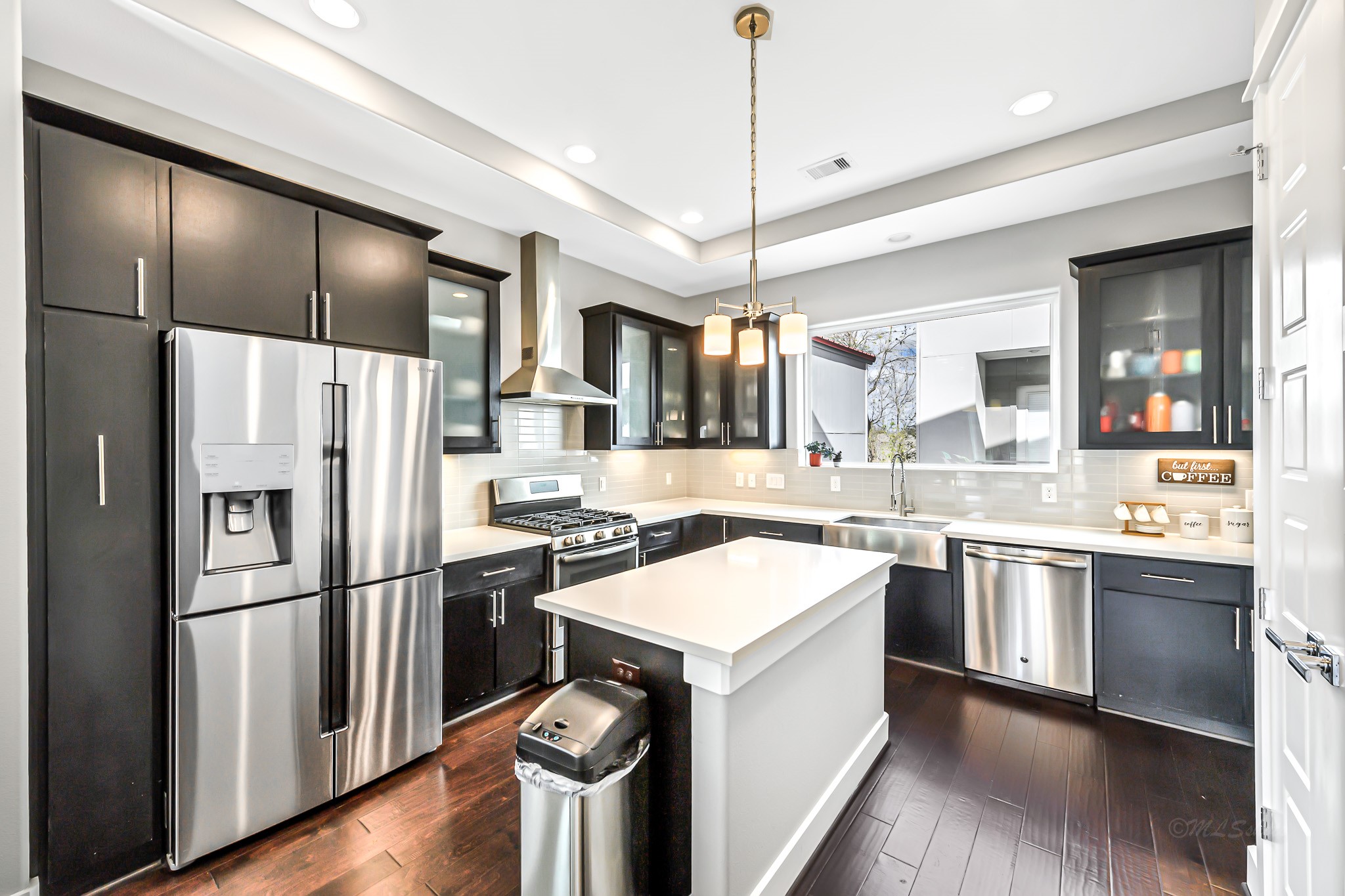 3105 Gillespie Street Houston, TX 77020 - Photo 20 of 43 a kitchen with a refrigerator a sink and wooden floor