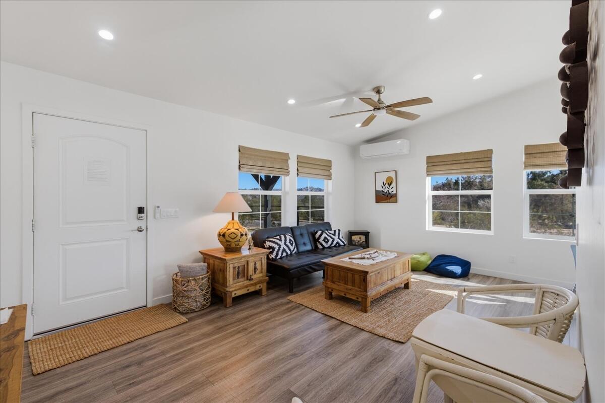 4884 Avenida Del Sol Joshua Tree, CA 92252 - Photo 12 of 66 a living room with furniture a chandelier and a window