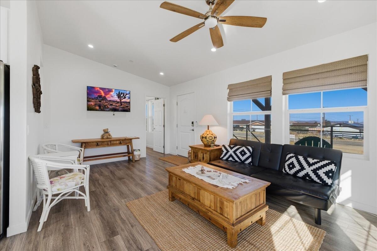 4884 Avenida Del Sol Joshua Tree, CA 92252 - Photo 14 of 66 a living room with furniture a rug and a flat screen tv