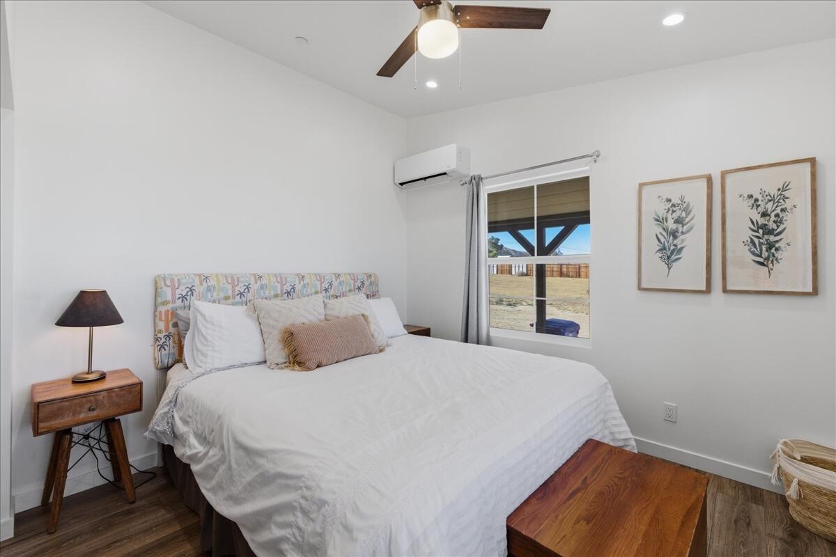 4884 Avenida Del Sol Joshua Tree, CA 92252 - Photo 23 of 66 a bedroom with a bed and a lamp on table
