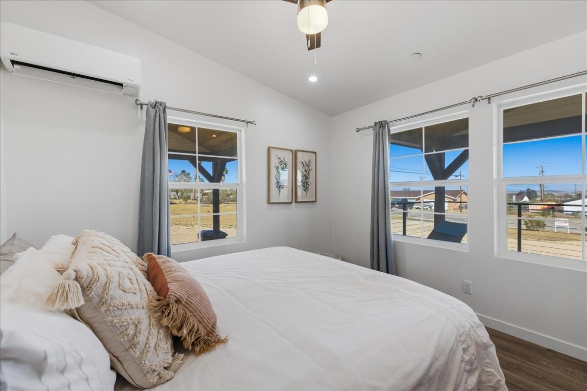 4884 Avenida Del Sol Joshua Tree, CA 92252 - Photo 26 of 66 a bedroom with a large bed and a window