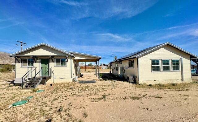 4884 Avenida Del Sol Joshua Tree, CA 92252 - Photo 3 of 66 a front view of a house with a yard