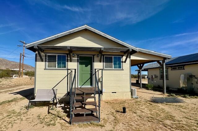 4884 Avenida Del Sol Joshua Tree, CA 92252 - Photo 39 of 66 a front view of a house with garden