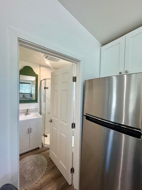 4884 Avenida Del Sol Joshua Tree, CA 92252 - Photo 46 of 66 a view of a refrigerator in kitchen and wooden floor