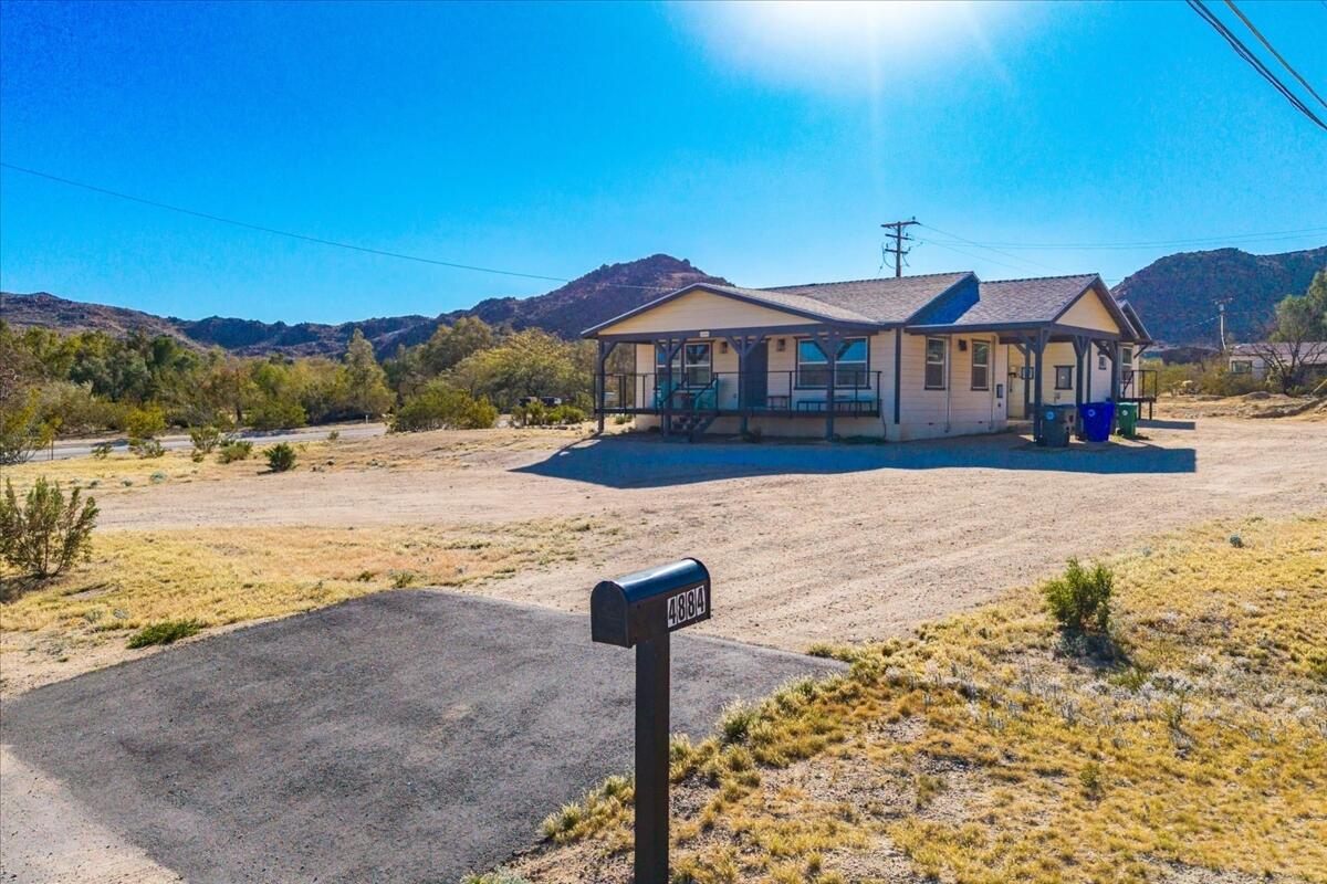 4884 Avenida Del Sol Joshua Tree, CA 92252 - Photo 50 of 66 a front view of a house with a yard