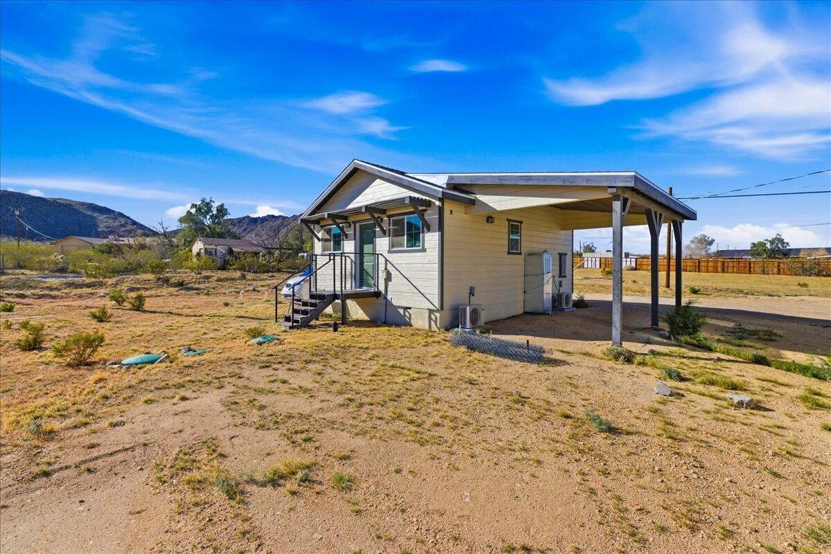 4884 Avenida Del Sol Joshua Tree, CA 92252 - Photo 58 of 66 a view of a house with a yard
