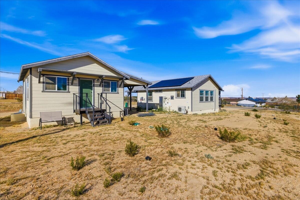 4884 Avenida Del Sol Joshua Tree, CA 92252 - Photo 59 of 66 a front view of a house with a yard