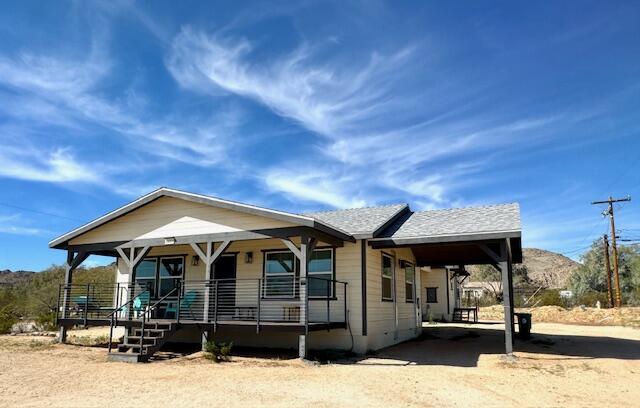 4884 Avenida Del Sol Joshua Tree, CA 92252 - Photo 8 of 66 a front view of a house with a yard