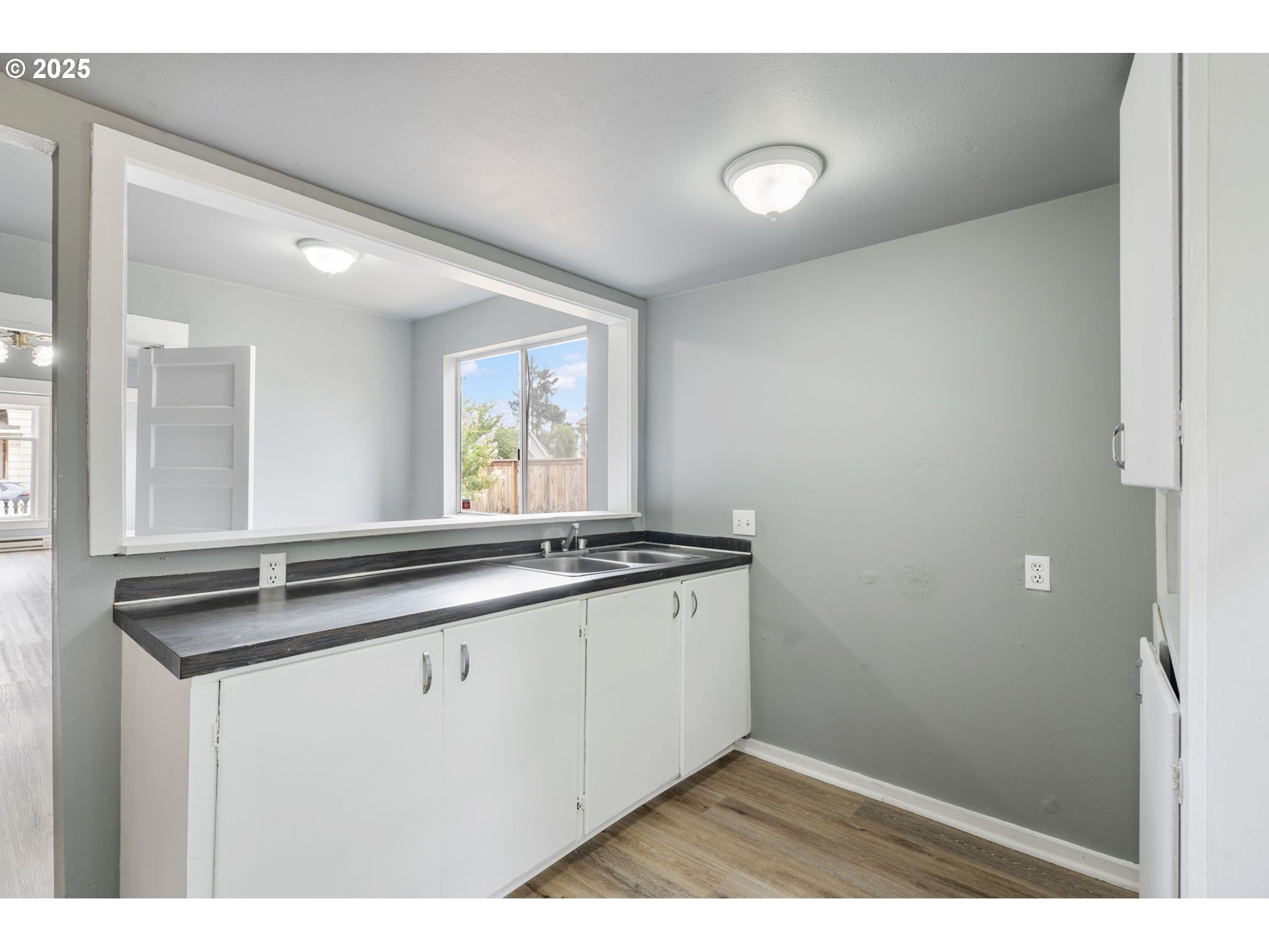 2035 4th Street Northeast Salem, OR 97301 - Photo 14 of 45 a kitchen with granite countertop a sink and a white cabinets
