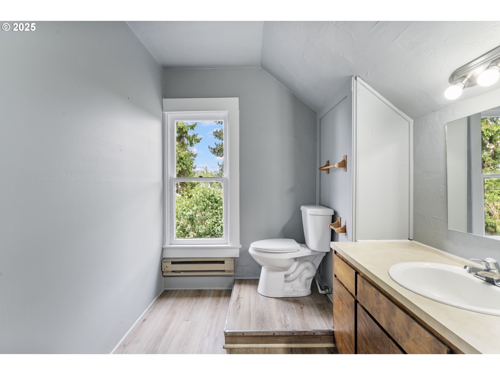 2035 4th Street Northeast Salem, OR 97301 - Photo 20 of 45 a bathroom with a granite countertop toilet a sink and a mirror