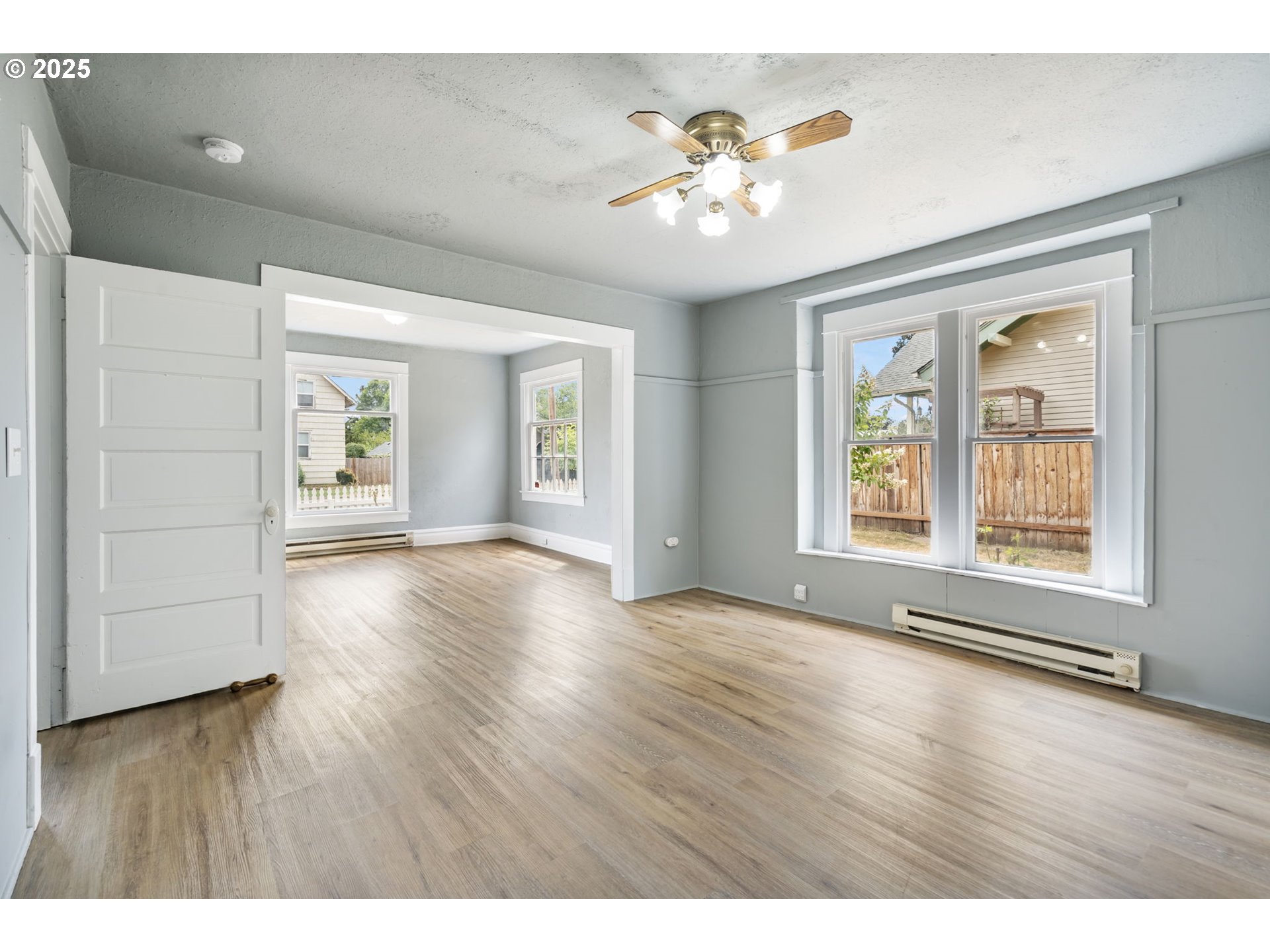 2035 4th Street Northeast Salem, OR 97301 - Photo 5 of 45 an empty room with wooden floor and windows