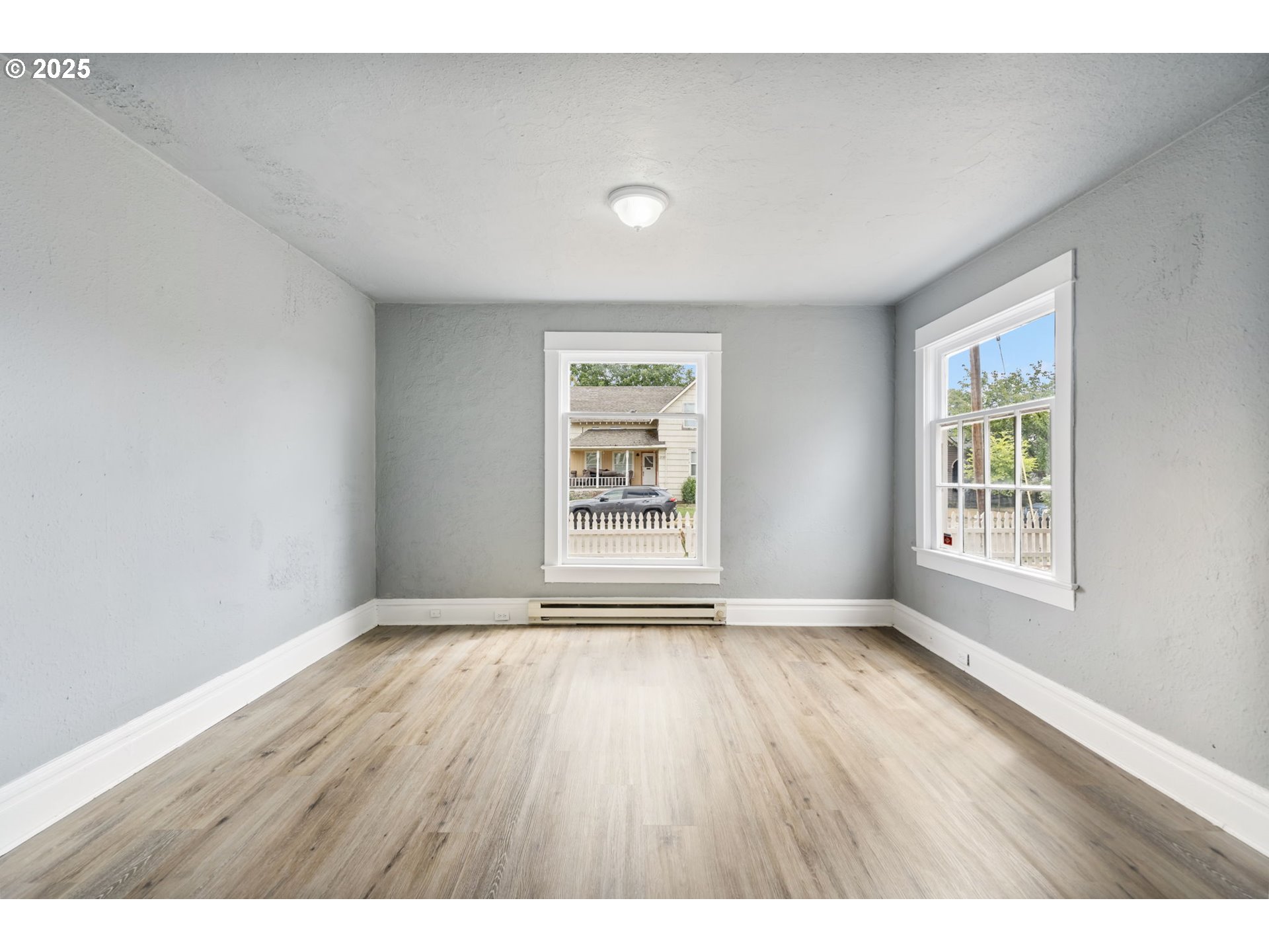 2035 4th Street Northeast Salem, OR 97301 - Photo 8 of 45 a view of an empty room with wooden floor and a window