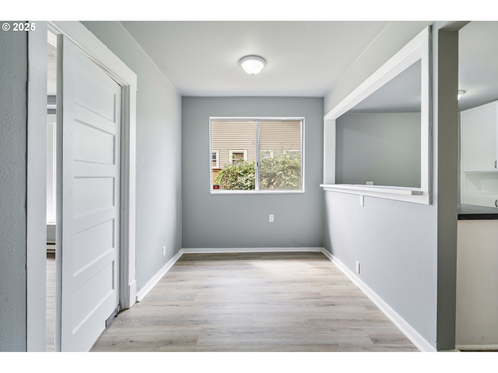 2035 4th Street Northeast Salem, OR 97301 - Photo 10 of 45 a view of an empty room with wooden floor and a window