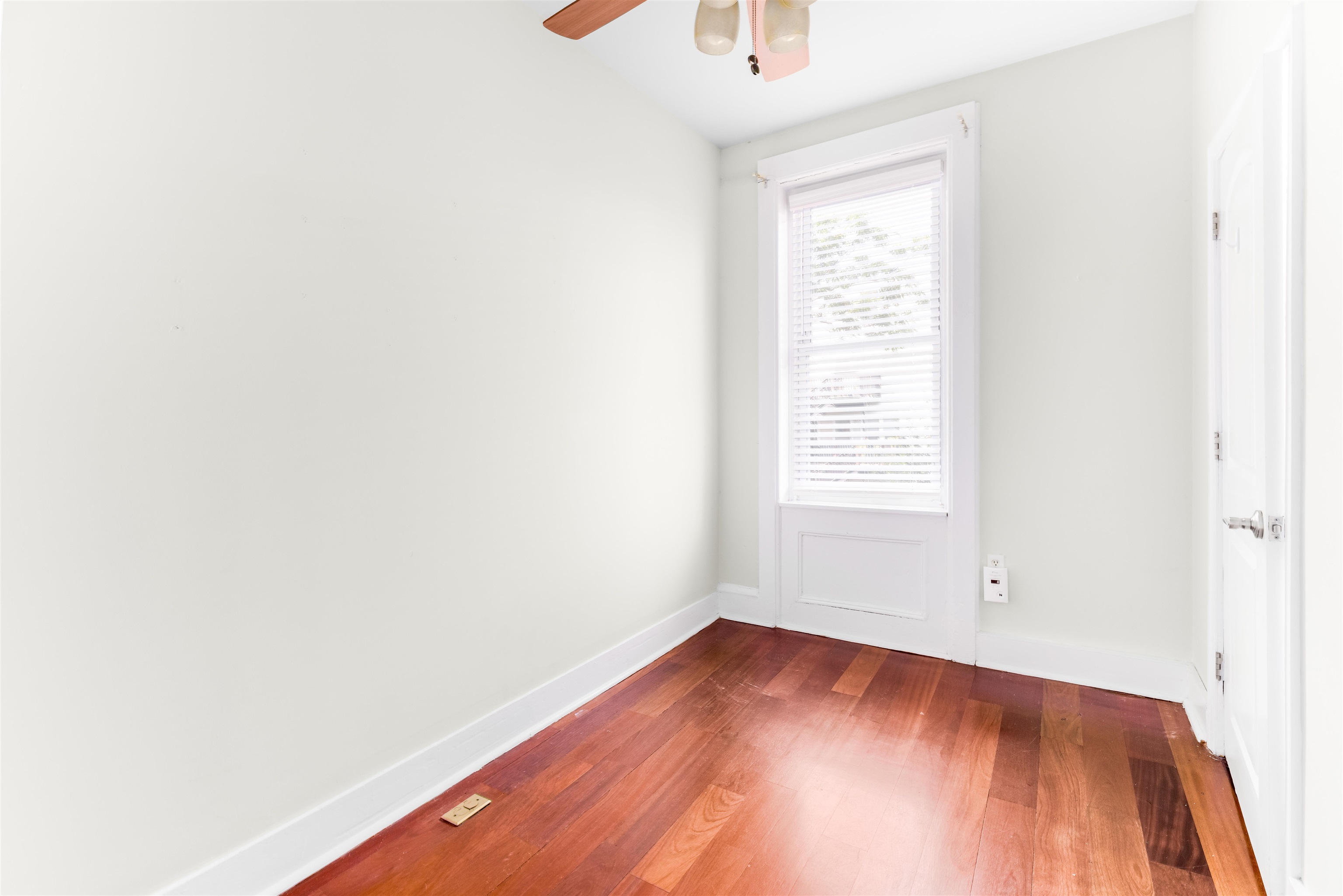 228 Jefferson Street, Unit 2 (R) Hoboken, NJ 07030 - Photo 12 of 15 a view of an empty room with wooden floor and a window