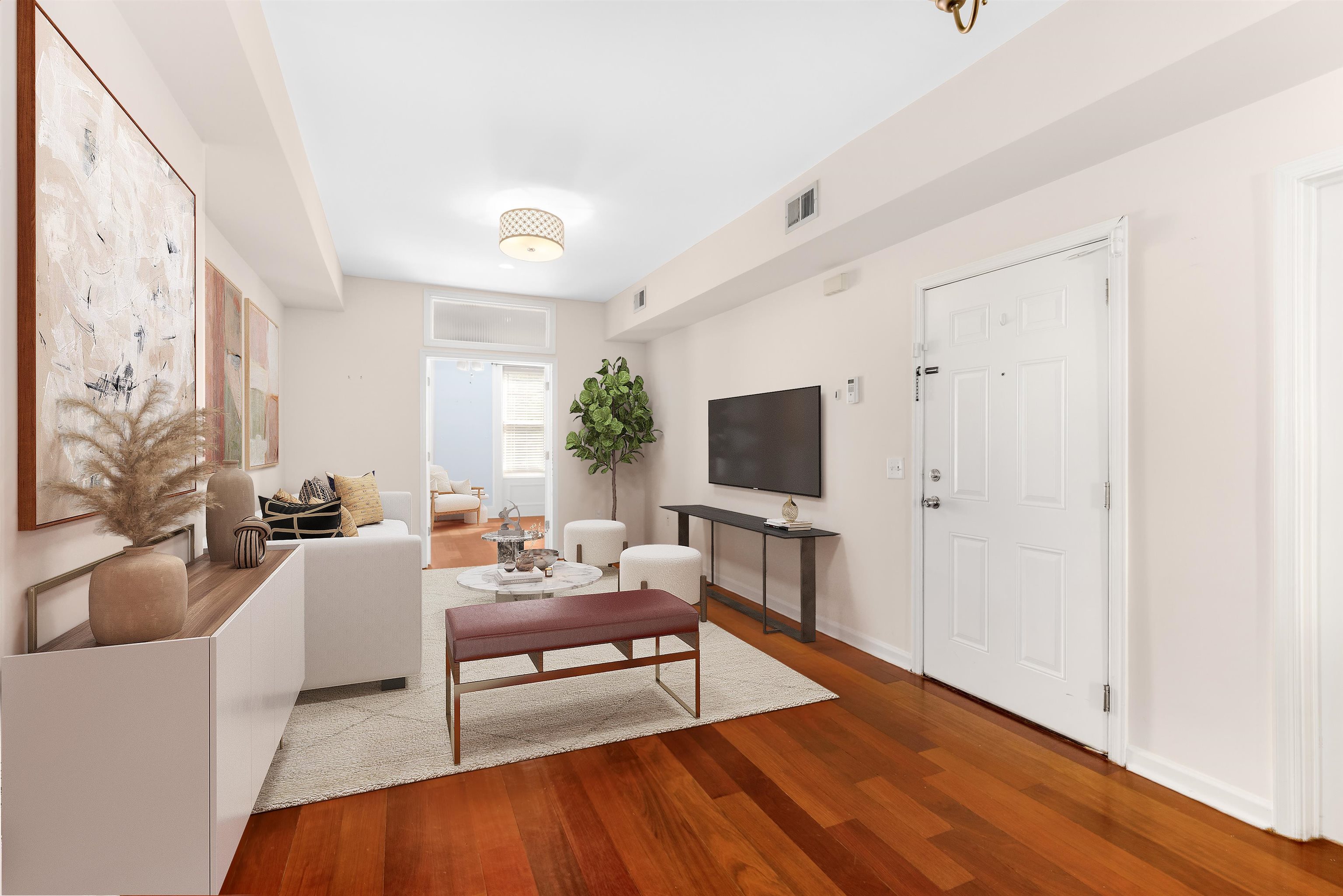 228 Jefferson Street, Unit 2 (R) Hoboken, NJ 07030 - Photo 3 of 15 a living room with furniture and a flat screen tv