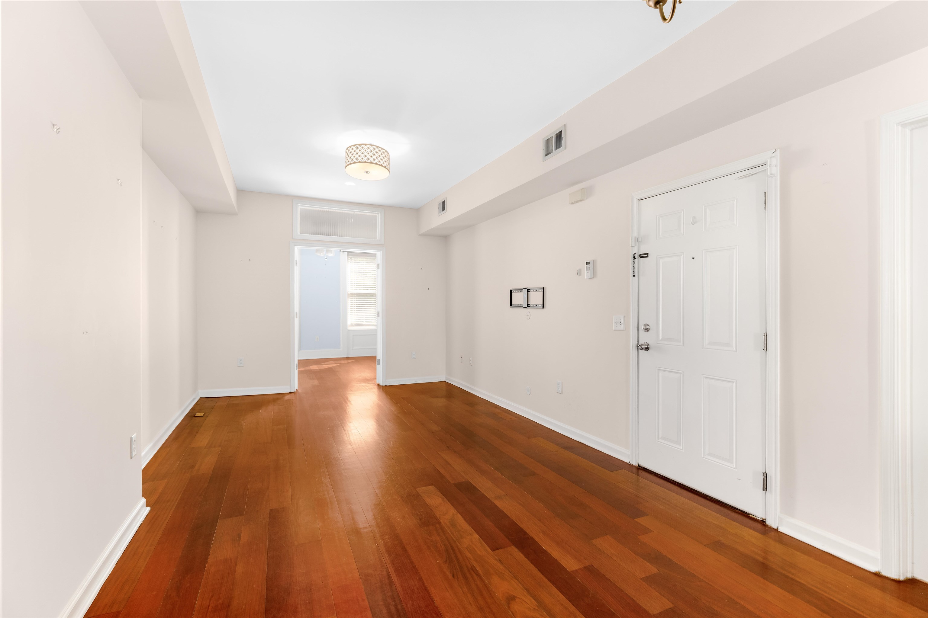 228 Jefferson Street, Unit 2 (R) Hoboken, NJ 07030 - Photo 4 of 15 a view of an empty room and wooden floor