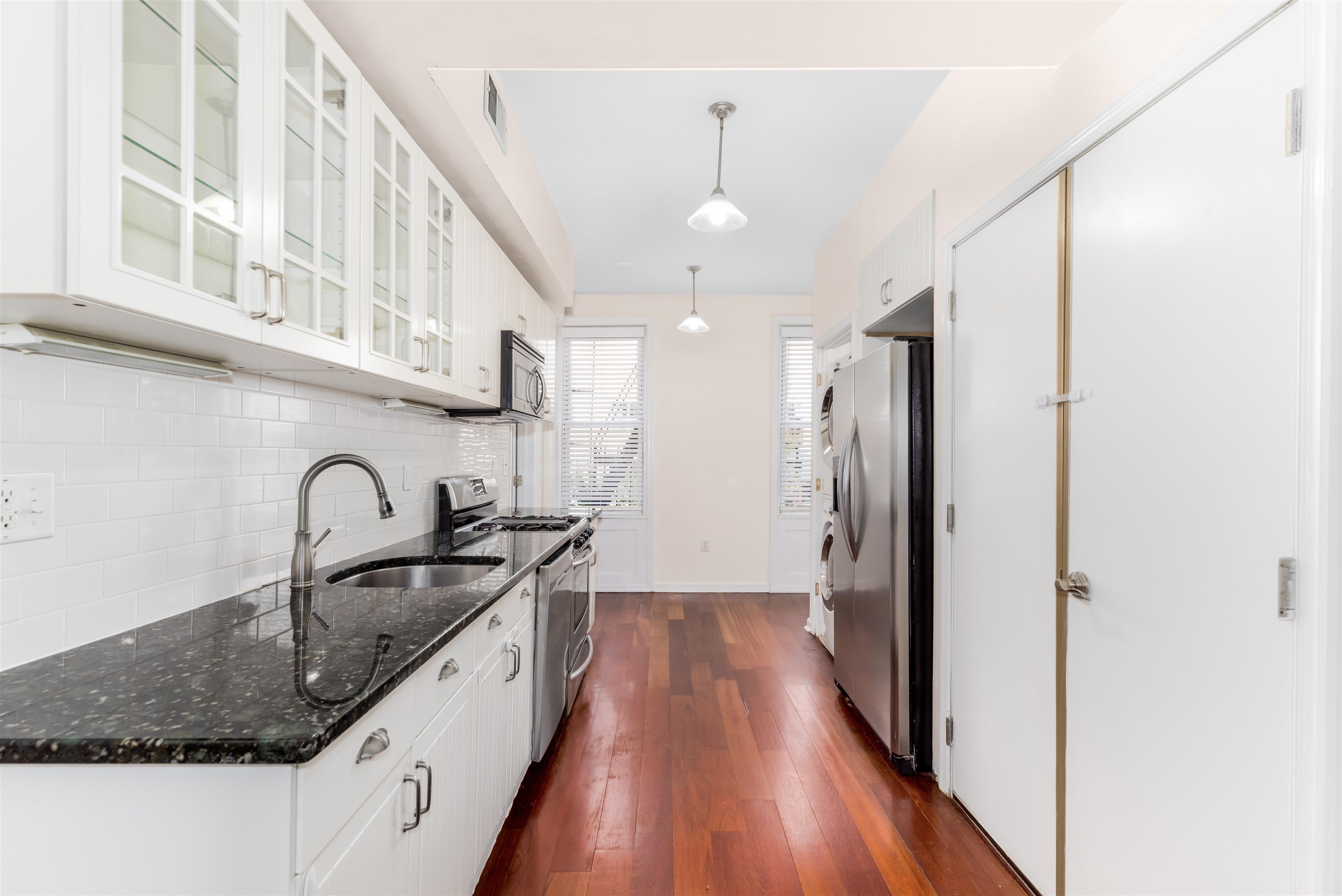 228 Jefferson Street, Unit 2 (R) Hoboken, NJ 07030 - Photo 5 of 15 a kitchen with granite countertop stainless steel appliances a sink and cabinets