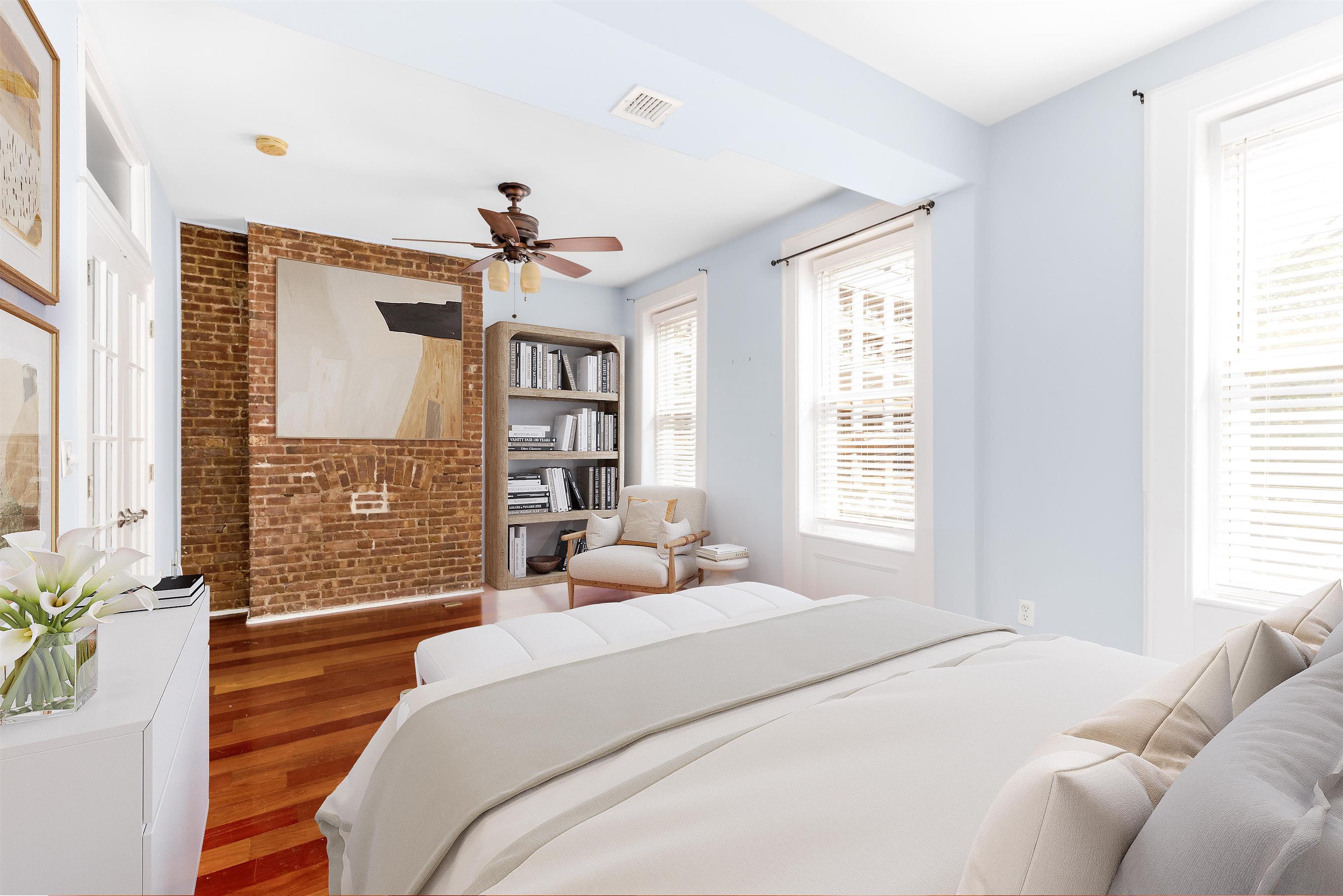 228 Jefferson Street, Unit 2 (R) Hoboken, NJ 07030 - Photo 9 of 15 a bedroom with a large bed chandelier and a window