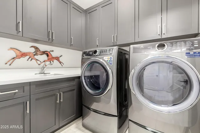 a utility room with sink dryer and washer