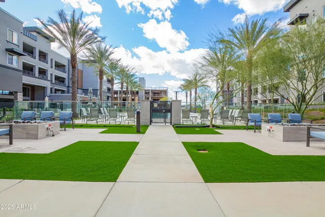 a view of a building with garden and tall trees