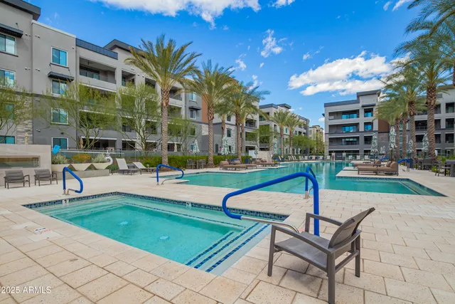 a view of a building with a swimming pool and sitting area