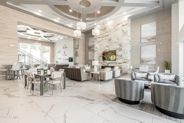 a room with lots of tables a large window and chairs