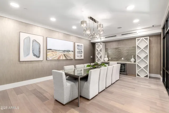 a living room with furniture a large window and a chandelier