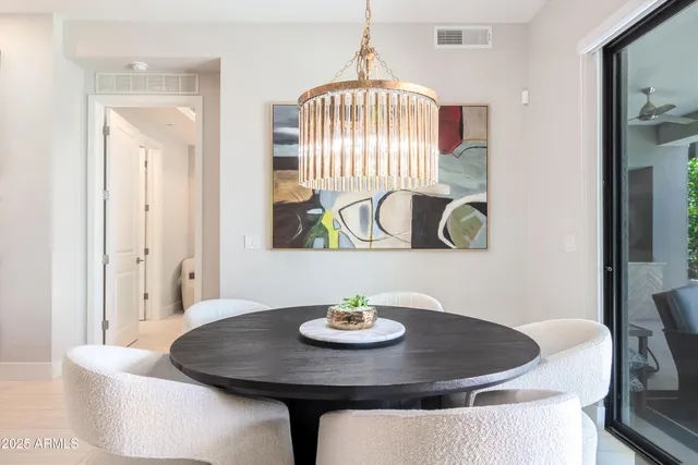 a dining room with table and chairs
