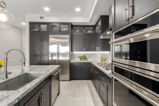 a kitchen with a sink and stainless steel appliances