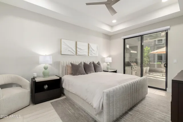 a bedroom with a large bed and a large window