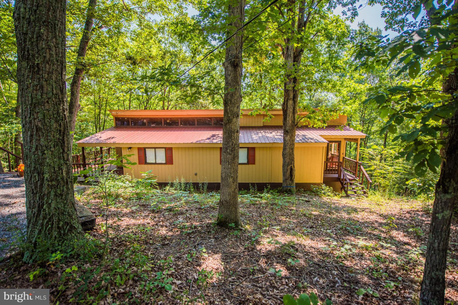 116 Hickory Hollow Road Berkeley Springs, WV 25411 - Photo 2 of 30 a view of a house with backyard and a tree