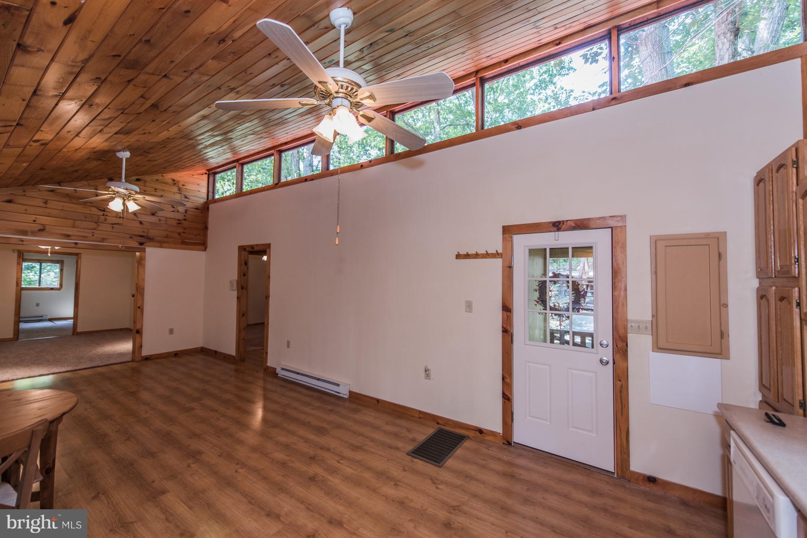116 Hickory Hollow Road Berkeley Springs, WV 25411 - Photo 6 of 30 wooden floor in an empty room with a window