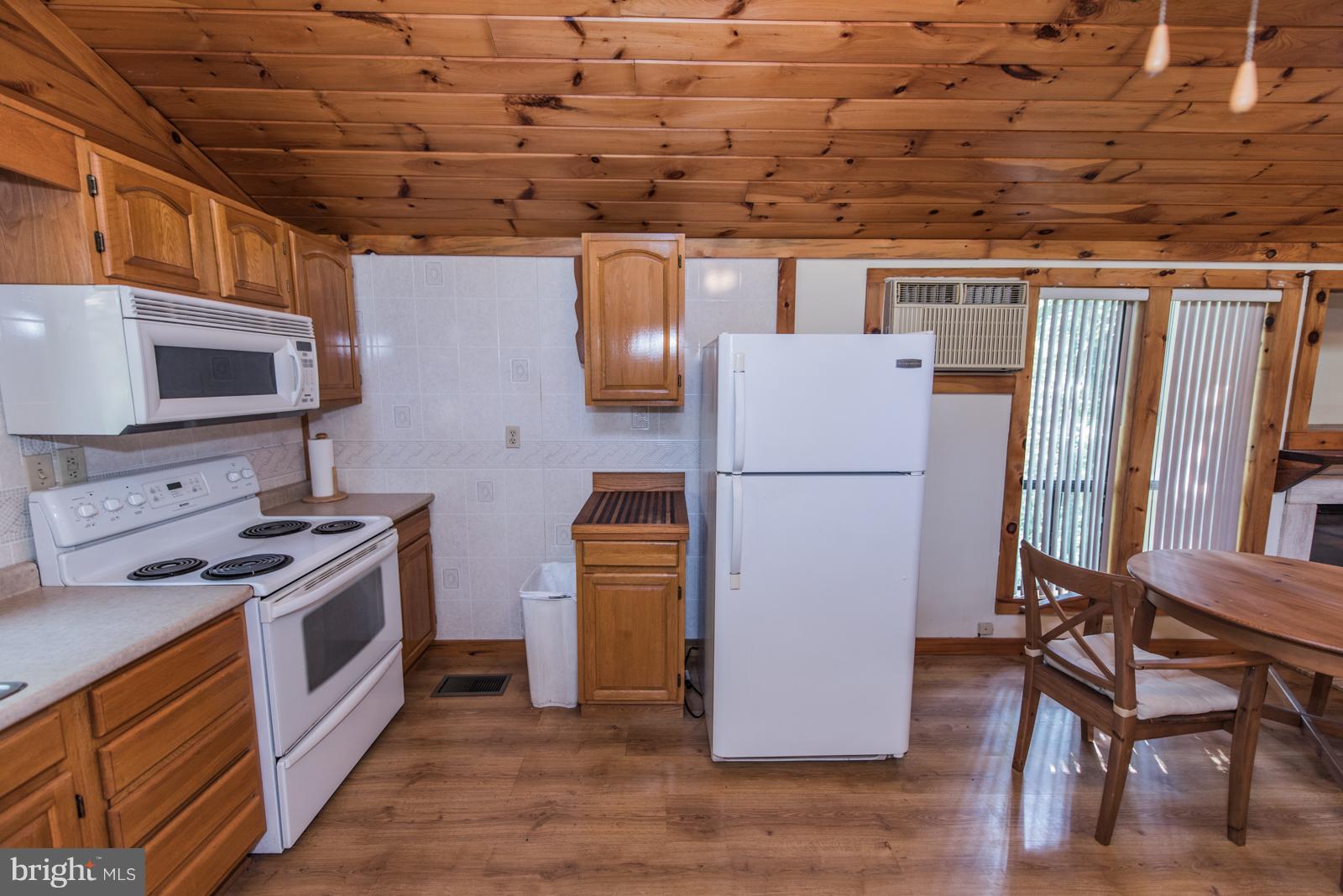 116 Hickory Hollow Road Berkeley Springs, WV 25411 - Photo 7 of 30 a kitchen with a refrigerator and a stove