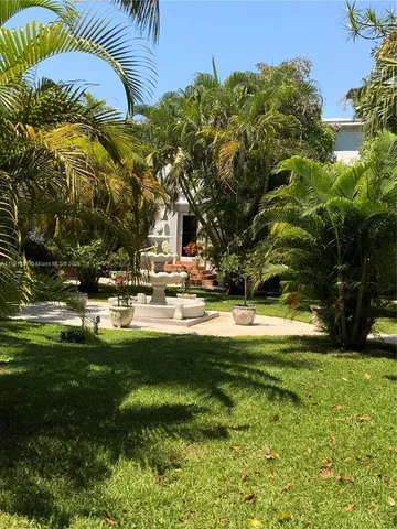 a swimming pool with outdoor seating and yard