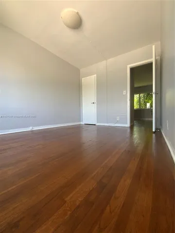 a view of an empty room and wooden floor