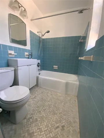 a bathroom with a sink a toilet and bathtub