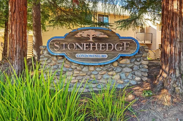 a view of a sign of a park next to a road