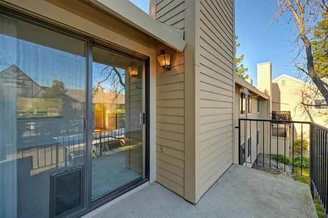 a view of a balcony with wooden fence and floor