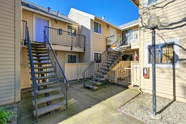 a view of a house with wooden stairs