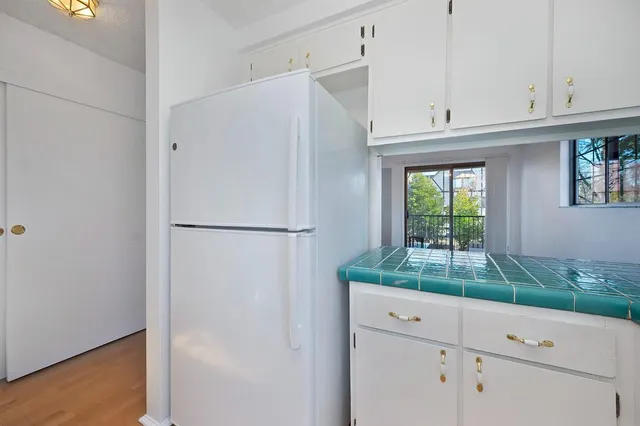 a white refrigerator freezer sitting in a kitchen