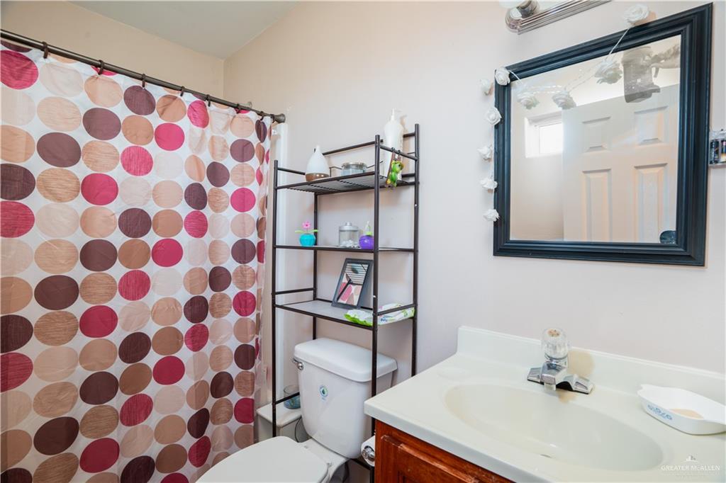 24609 Ocean Street Monte Alto, TX 78538 - Photo 11 of 31 a bathroom with a sink toilet and shower