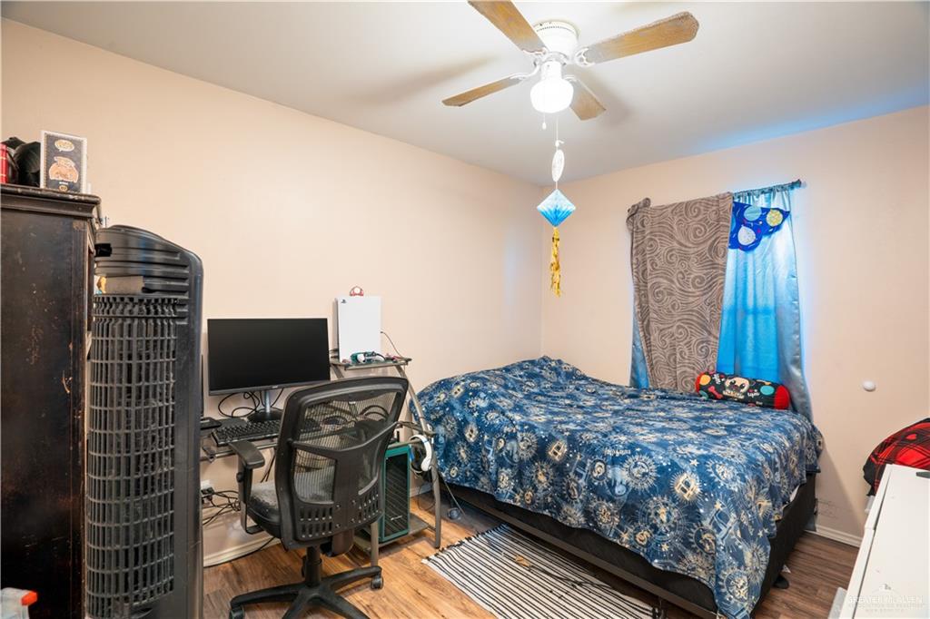 24609 Ocean Street Monte Alto, TX 78538 - Photo 14 of 31 a bedroom with a bed and a flat screen tv