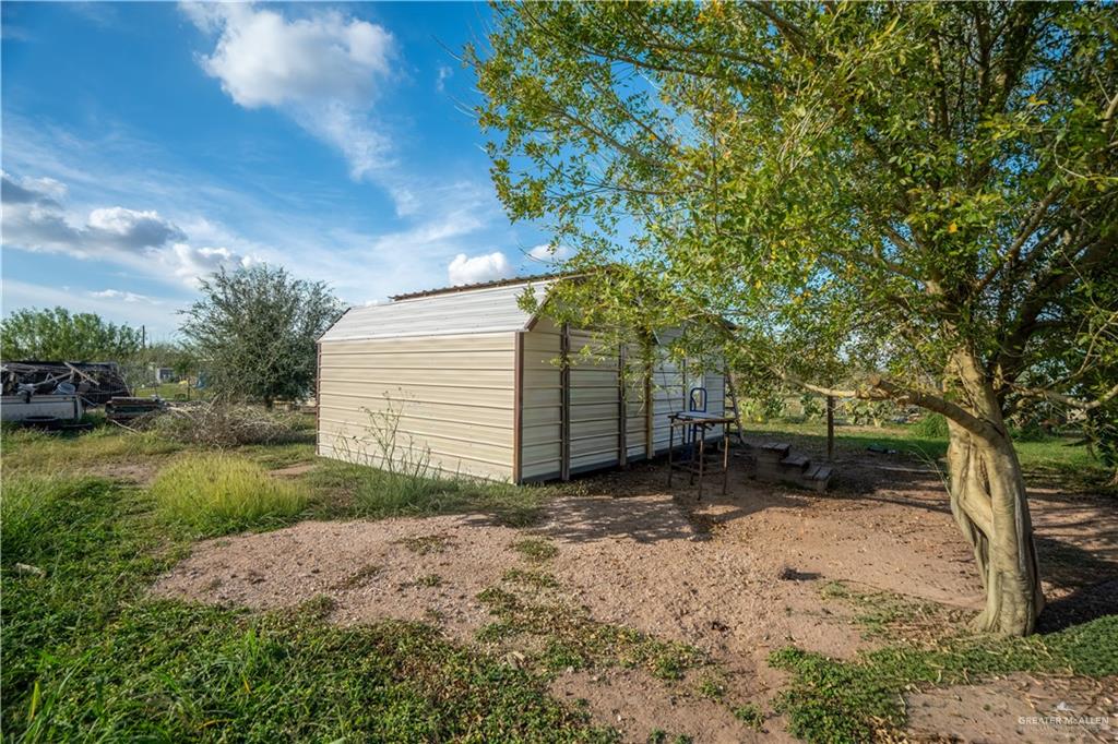 24609 Ocean Street Monte Alto, TX 78538 - Photo 18 of 31 a view of a backyard with large trees