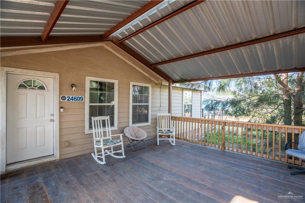 24609 Ocean Street Monte Alto, TX 78538 - Photo 3 of 31 a view of a deck with wooden floor and outdoor seating