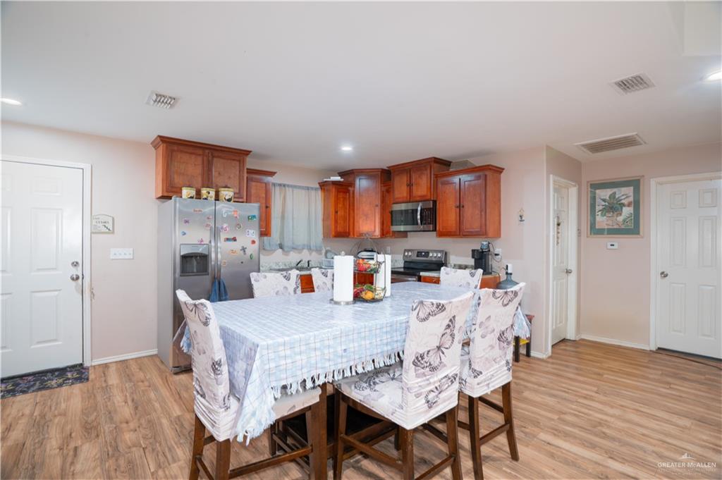 24609 Ocean Street Monte Alto, TX 78538 - Photo 6 of 31 a view of a dining room with furniture and wooden floor