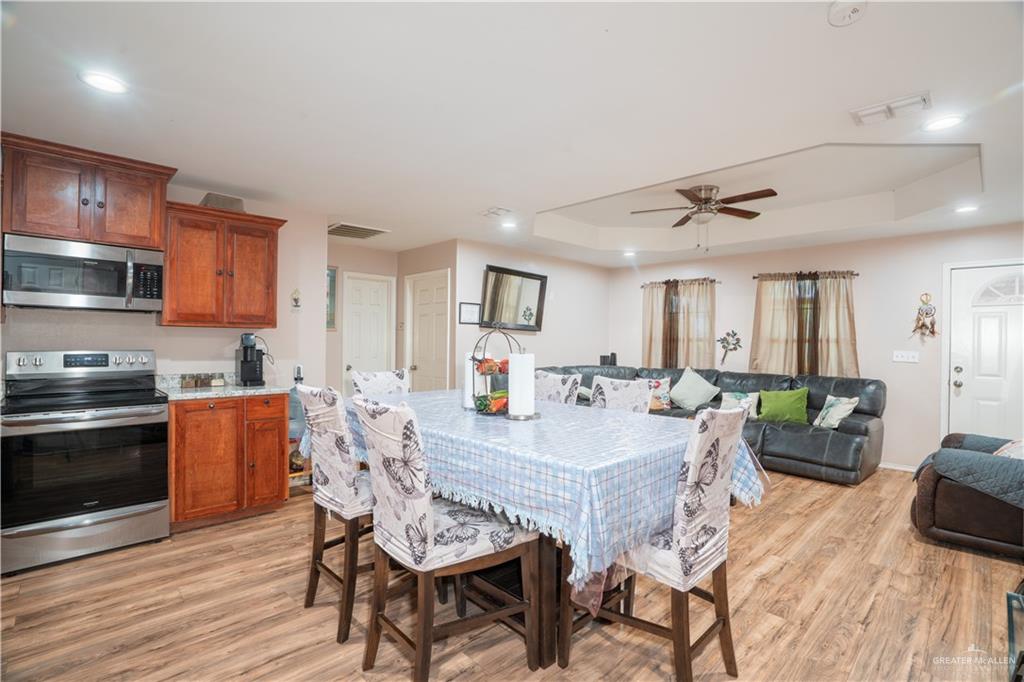 24609 Ocean Street Monte Alto, TX 78538 - Photo 7 of 31 a view of a dining room with furniture and wooden floor