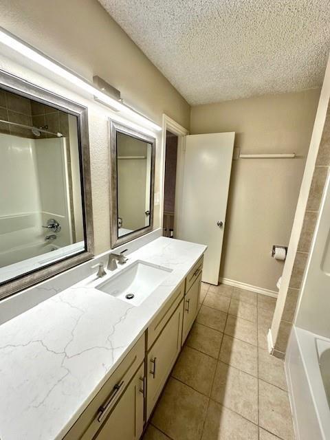 4119 Spring Meadow Lane Flower Mound, TX 75028 - Photo 18 of 28 a spacious bathroom with a double vanity sink and a mirror