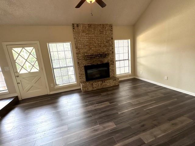 4119 Spring Meadow Lane Flower Mound, TX 75028 - Photo 5 of 28 an empty room with wooden floor fireplace and windows