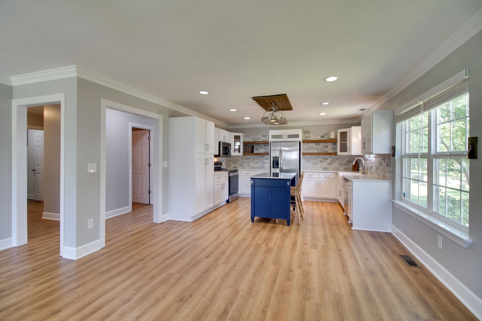 1334 Davy Crockett Drive Murfreesboro, TN 37129 - Photo 12 of 45 a living room with stainless steel appliances granite countertop a refrigerator a sink dishwasher with wooden cabinets and dining table with wooden floor
